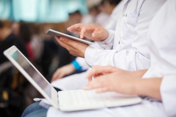 medical students with tablets and laptops