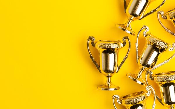 awards on a yellow background